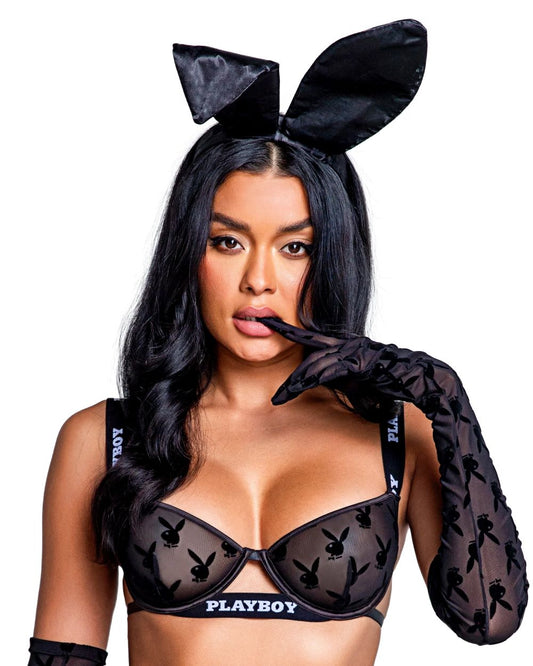 A woman with bunny ears accessory by Playboy, also wearing the playboy gloves and bra